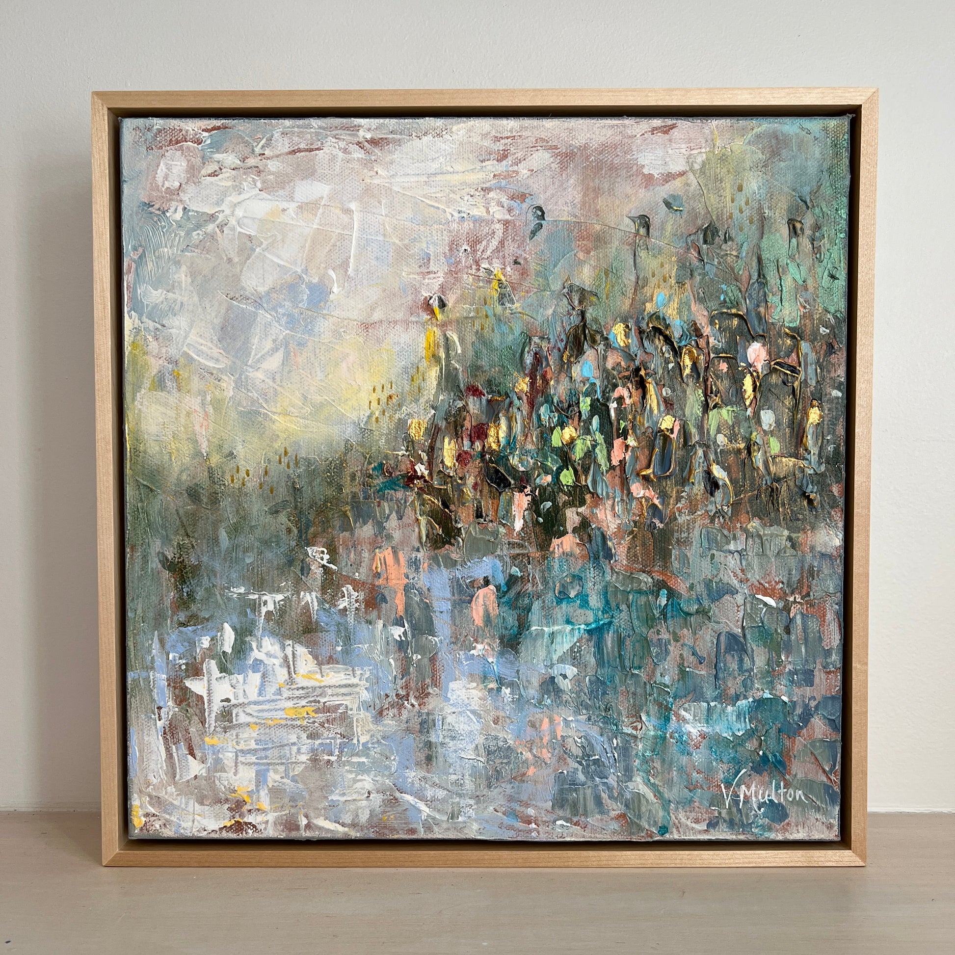 Abstract painting in a wooden frame on a wall